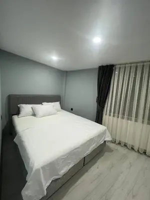 a bedroom with a large white bed and a window at Seaway Hotel İstanbul in Istanbul