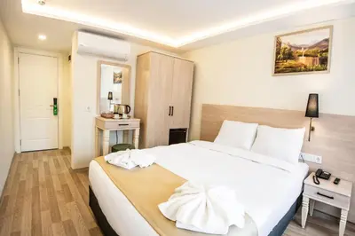 a bedroom with a large white bed in a room at Royal Bosphorus Hotel & SPA Hamam in Istanbul