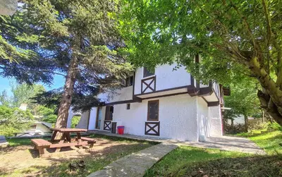 a picnic table in front of a house with trees at Polonezköy Country Club & Accommodation in the Wildlife Park! in Beykoz