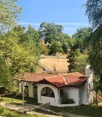 a building with a red roof and a field at Polonezköy Country Club & Accommodation in the Wildlife Park! in Beykoz
