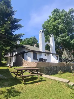a picnic table in front of a house with a large letter ak at Polonezköy Country Club & Accommodation in the Wildlife Park! in Beykoz