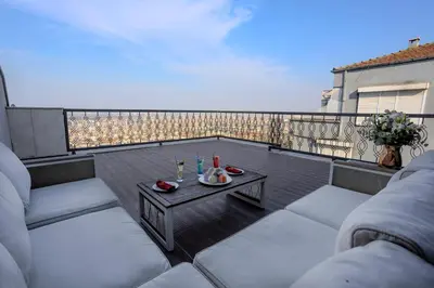 a patio with two couches and a table on a balcony at Royal Termal Hotel in Bursa