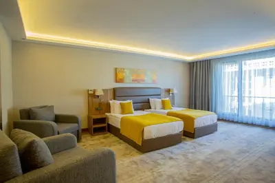 a hotel room with two beds and a couch at Royal Termal Hotel in Bursa