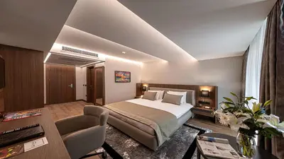 a bedroom with a bed and a table and a couch at Vital Hotel Fulya Istanbul Sisli in Istanbul