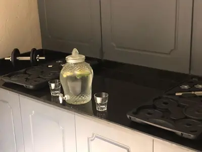 a glass jar on a kitchen counter with two glasses at Ferman Port Hotel - Special Category in Istanbul