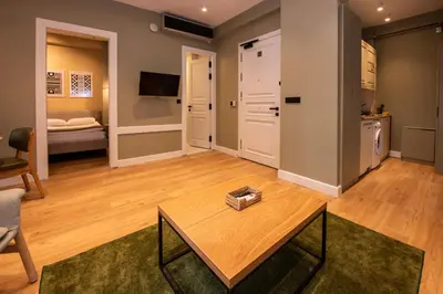 a living room with a table and a kitchen at Bguest Pera Suites in Istanbul
