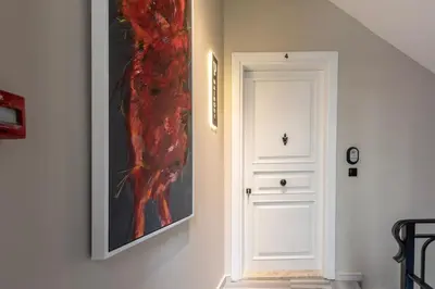 a painting hanging on a wall next to a door at Bguest Pera Suites in Istanbul