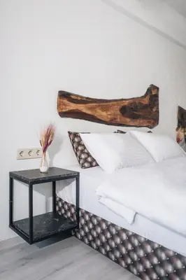 a bedroom with a bed and a side table at PANDAN KARAKOY SUİT in Istanbul