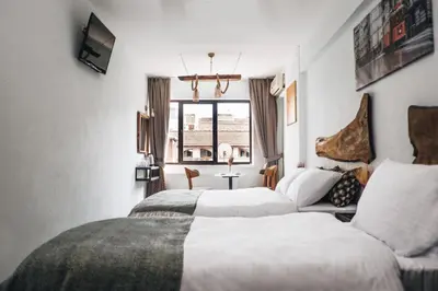 a hotel room with two beds and a window at PANDAN KARAKOY SUİT in Istanbul