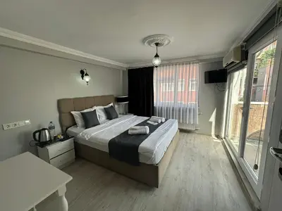 a bedroom with a large bed and a large window at Rose Bouquets Hotel in Istanbul