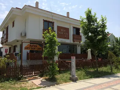 a white building with a sign in front of it at Ağva Piassa Otel in Agva