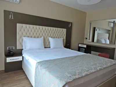 a bedroom with a large bed and a large mirror at Senler Boutique Hotel in Sapanca
