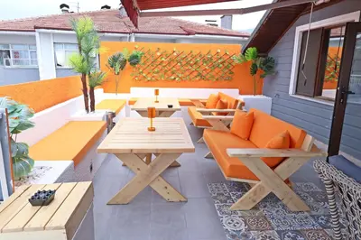 an outdoor patio with wooden tables and benches at Hotel Ipekyolu in Sapanca