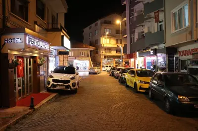 a city street at night with cars parked at Hotel Ipekyolu in Sapanca