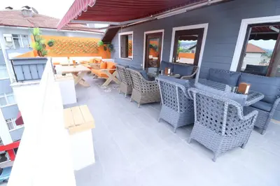 a patio with wicker chairs and tables on a building at Hotel Ipekyolu in Sapanca