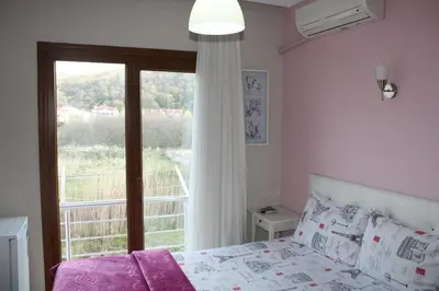 a bedroom with a bed and a large window at Sapphire Hotel in Agva