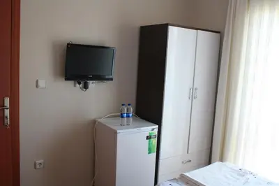a room with a refrigerator and a flat screen tv at Sapphire Hotel in Agva
