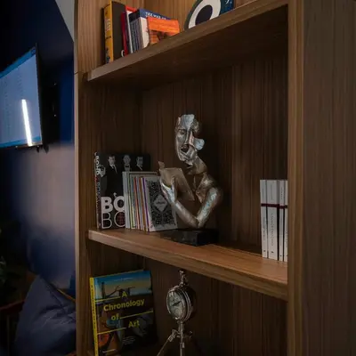 a book shelf with a statue of a man reading at Kepler Club Sabiha Gökçen Airport - International Transit Area in Istanbul