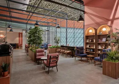 a restaurant with chairs and tables and plants at Kepler Club Sabiha Gökçen Airport - International Transit Area in Istanbul