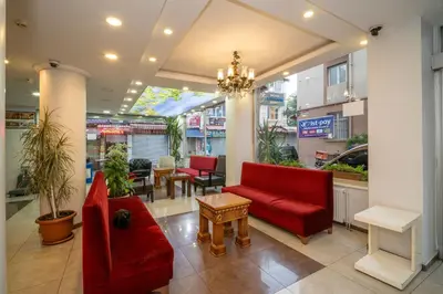 a store lobby with red chairs and a table at Hotel Simper in Istanbul