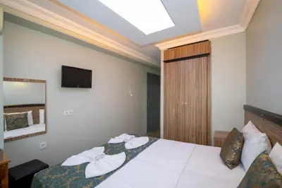 a hotel room with a bed with towels on it at Hotel Simper in Istanbul