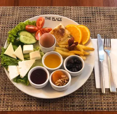 a plate of food with different types of food on it at Ataşehir The Place Suites in Istanbul