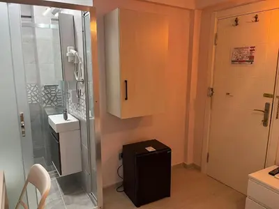 a bathroom with a shower and a toilet and a sink at Zion Home Butik Otel in Istanbul