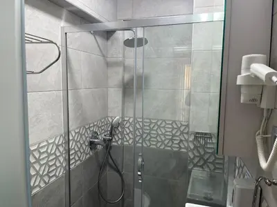 a shower with a glass door in a bathroom at Zion Home Butik Otel in Istanbul