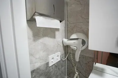 a hair dryer in a bathroom with a phone at Zion Home Butik Otel in Istanbul