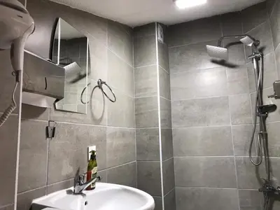 a bathroom with a sink and a shower at Zion Home Butik Otel in Istanbul