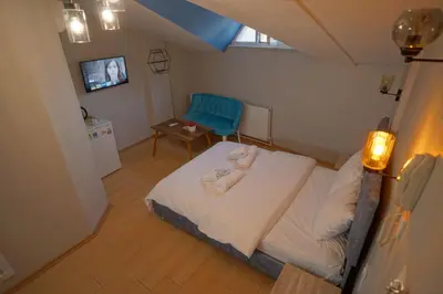 a small room with a bed and a chair at Zion Home Butik Otel in Istanbul