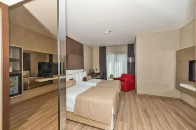 a hotel room with a bed and a tv at Istanbul Dora Hotel in Istanbul