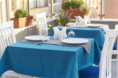 a blue table with white plates and napkins on it at Renzo Hotel - Special Category in Istanbul