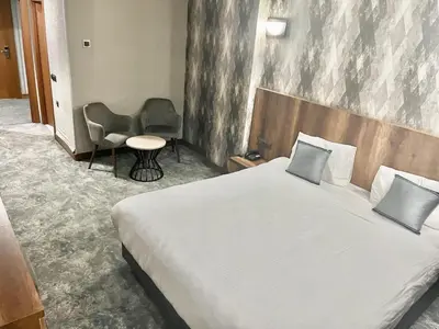 a hotel room with a bed and a chair at Istanbul Airport Express Hotel in Arnavutköy