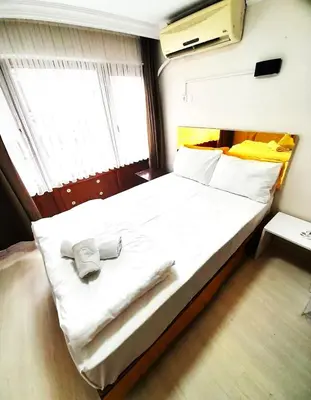 a bedroom with a large bed with white sheets and pillows at Ozbekler Hotel-Old City in Istanbul