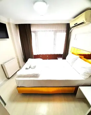 a bedroom with a large bed in front of a window at Ozbekler Hotel-Old City in Istanbul