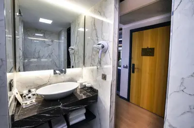 a bathroom with a sink and a mirror at Broyt Hotel in Istanbul