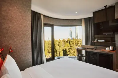 a bedroom with a white bed and a large window at Avantgarde Urban Sisli in Istanbul