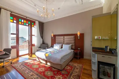 a bedroom with a bed and a chandelier at Blue Gilroy Hotel in Istanbul