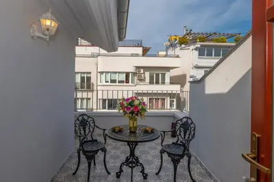 a balcony with a table and chairs and a building at Blue Gilroy Hotel in Istanbul