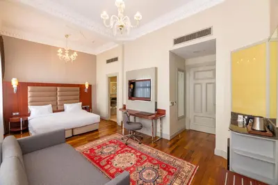 a bedroom with a bed and a television and a couch at Blue Gilroy Hotel in Istanbul