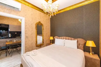 a bedroom with a bed and a dining room at Istanbul Taksim Residence Hotel By MESUT in Istanbul