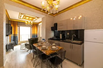 a kitchen and dining room with a table and chairs at Istanbul Taksim Residence Hotel By MESUT in Istanbul