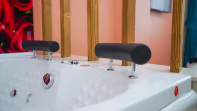 a white sink with two faucets on top of it at Luka Suit Hotel in Istanbul