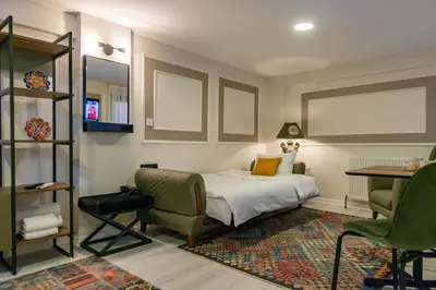 a bedroom with a bed and a table and chairs at BLUE MARMARA SUITES in Istanbul