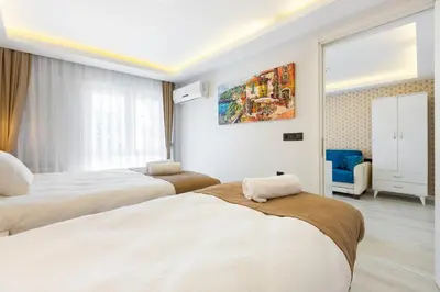 a hotel room with two beds and a window at BLUE MARMARA SUITES in Istanbul
