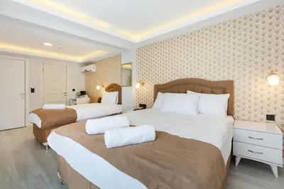 a hotel room with two beds with white sheets at BLUE MARMARA SUITES in Istanbul