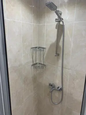 a shower with a shower head in a bathroom at Luna Suites Taksim in Istanbul