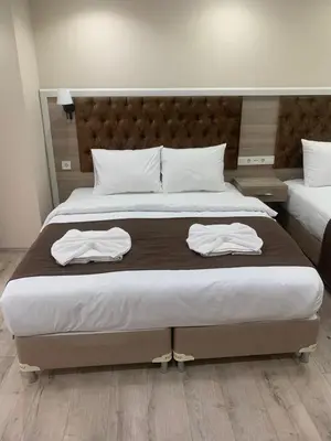 a bedroom with a large bed with two towels on it at Luna Suites Taksim in Istanbul