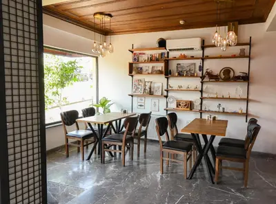 a dining room with tables and chairs and a window at Galata Dream Hotel in Istanbul